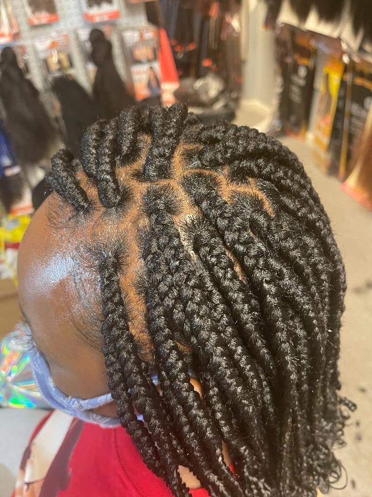 Medium knotless braids on clean square partings, seen from above